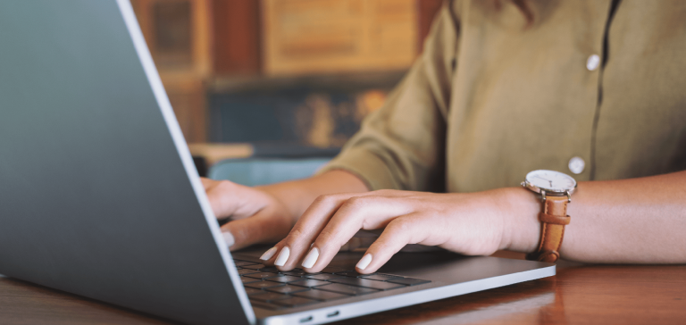 Closeup image woman's hands using typing laptop computer keyboard